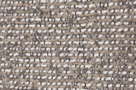 Textured patterned fabric with a mix of brown, beige, and white colors.